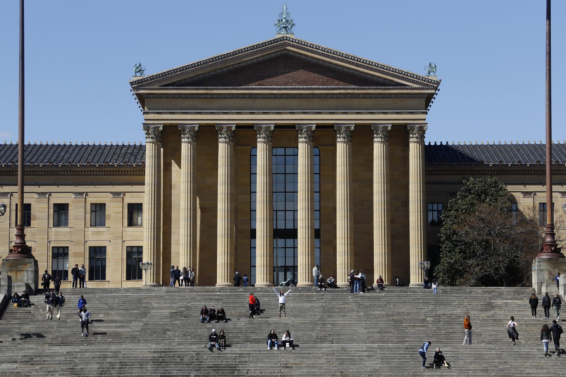People gather on the steps of The Philadelphia Museum of Art, Sunday, March 15, 2020, in Philadelphia. The museum has temporarily closed due to the COVID-19 pandemic.