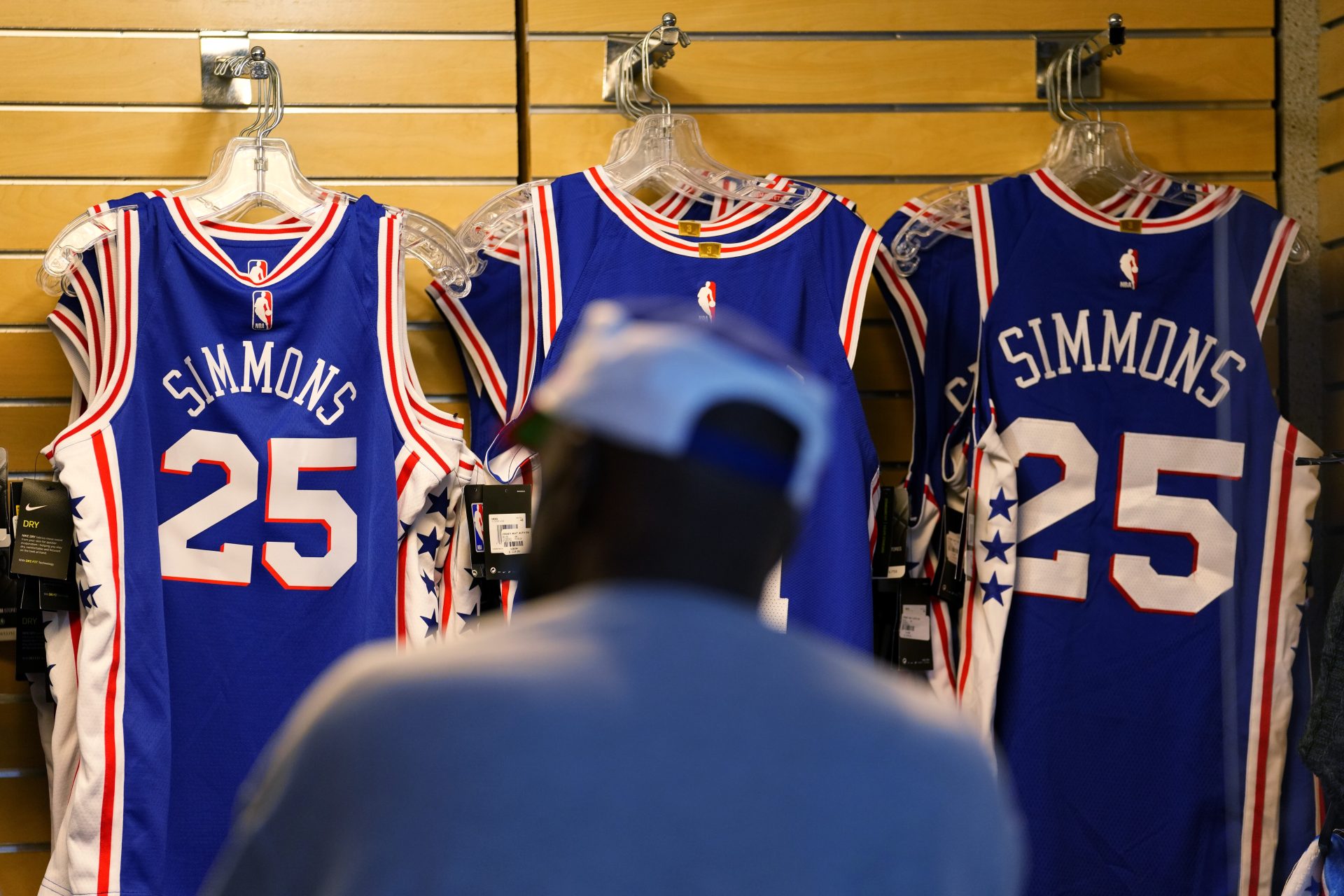 A fan shops for souvenirs before a preseason NBA basketball game between the Philadelphia 76ers and the Toronto Raptors, Thursday, Oct. 7, 2021, in Philadelphia.