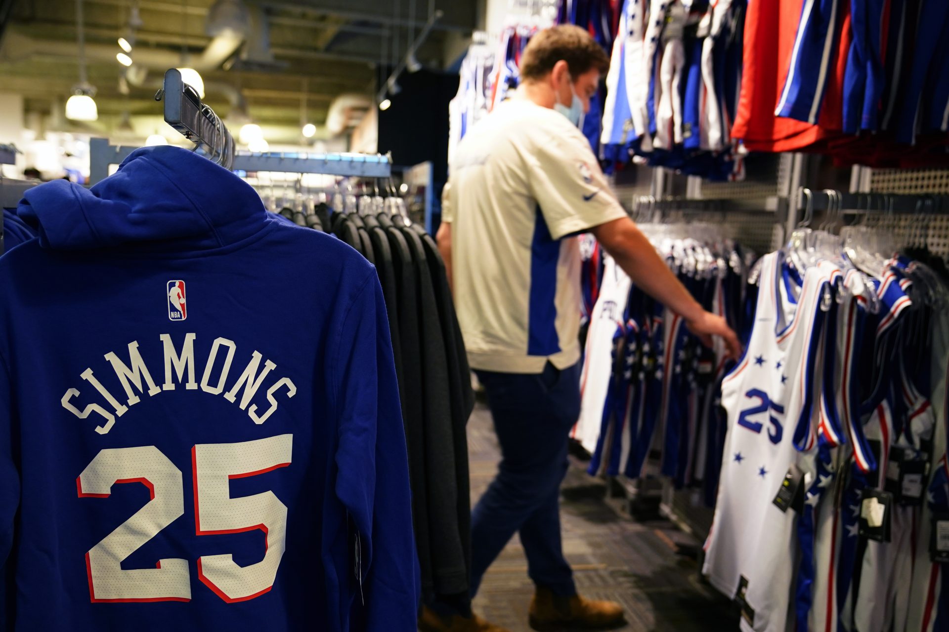 A fan shops for souvenirs before a preseason NBA basketball game between the Philadelphia 76ers and the Toronto Raptors, Thursday, Oct. 7, 2021, in Philadelphia.