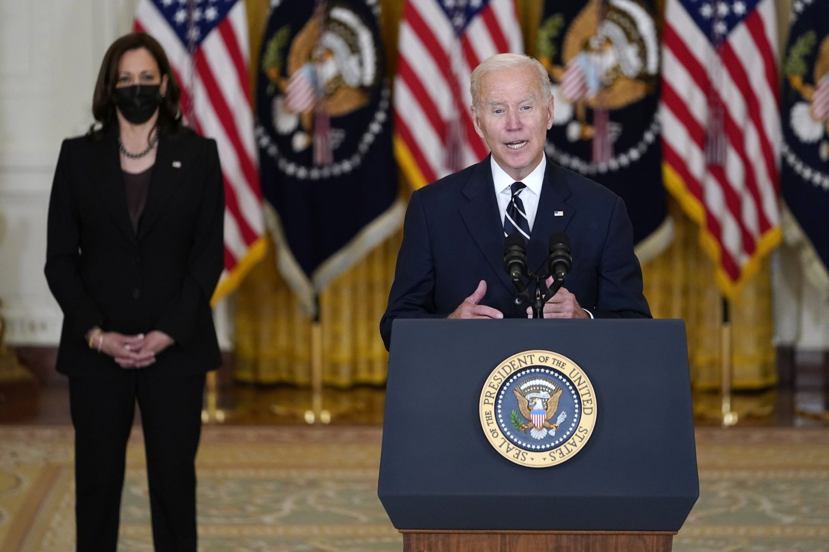 President Joe Biden speaks about his domestic agenda from the East Room of the White House in Washington, Thursday, Oct. 28, 2021, as Vice President Kamala Harris looks on. 