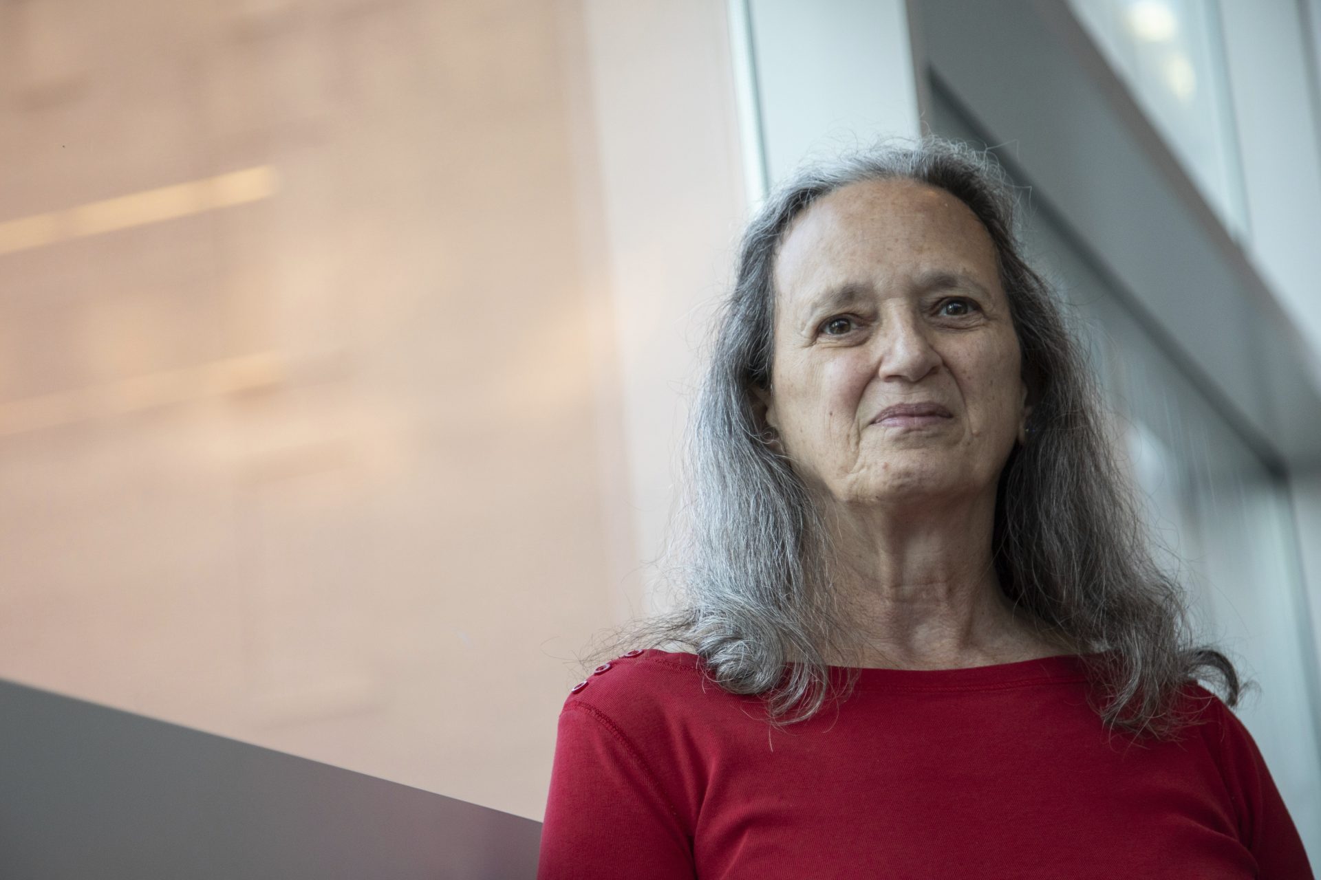 In this Monday, Oct. 18, 2021 photo, Carol Black, a survivor of the Oct. 27, 2018, mass shooting at the Tree of Life synagogue, poses for a portrait at the Eradicate Hate Global Summit in Pittsburgh. Black's brother, Richard Gottfried, was killed along with 10 other people in the attack.