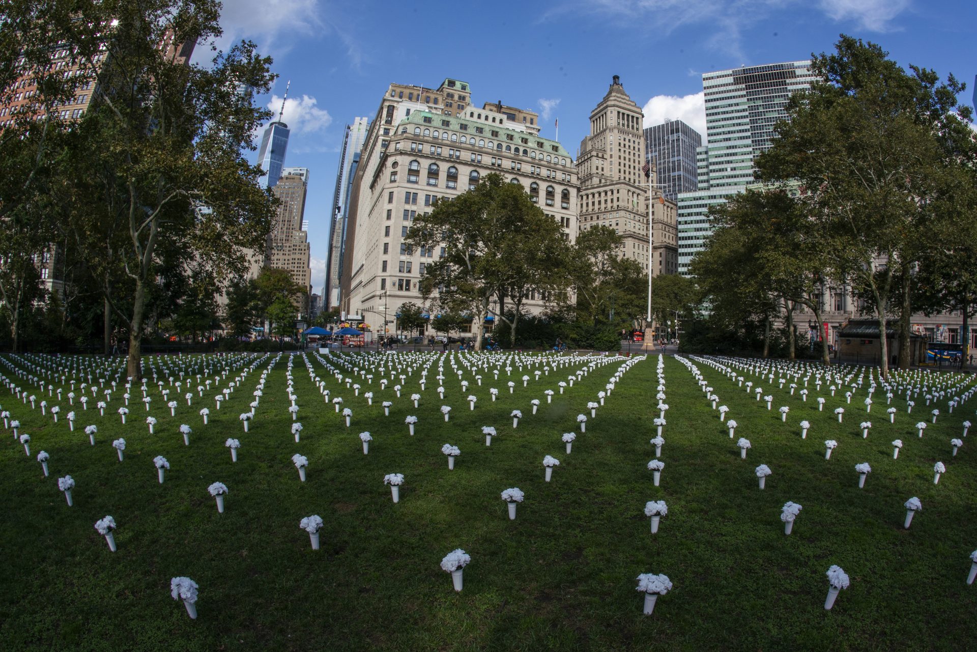 Vases full of white flowers, that are part of an installation of One-thousand-fifty vases filled with white flowers, representing 1,050 lives lost by gun violence in New York last year, while they are displayed at Battery Park, Thursday, Oct. 7, 2021, in New York.