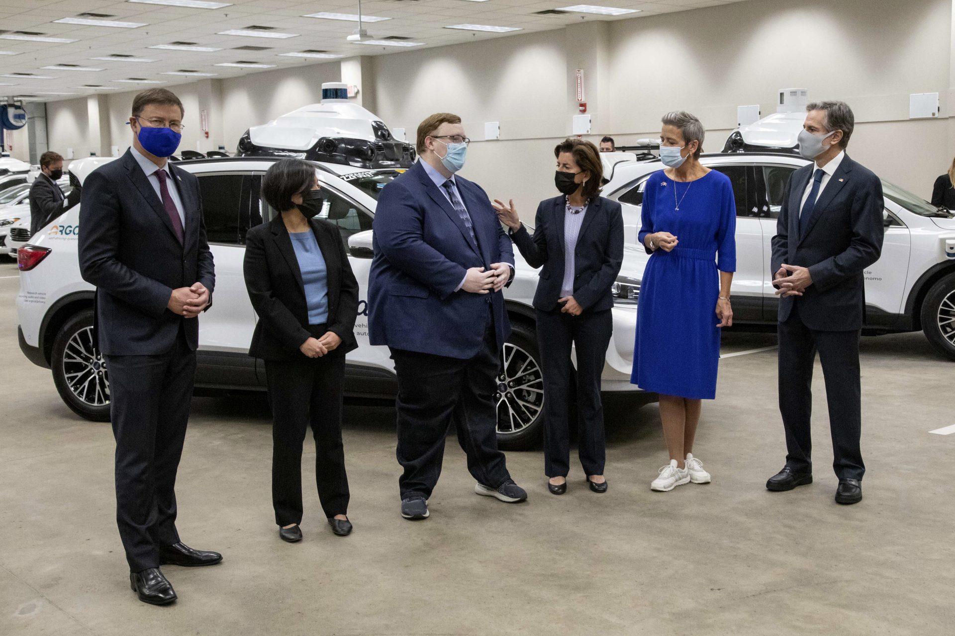 From left, European Commissioner Valdis Dombrovskis, U.S. Trade Representative Katherine Tai, ARGO CEO Bryan Salesky, Commerce Secretary Gina Raimondo, European Commissioner Margrethe Vestager and Secretary of State Antony Blinken, talk as they pose for photos on a tour of the ARGO facility during a meeting of the United States-European Union Trade and Technology Council (TTC), Thursday, Sept. 30, 2021, in Pittsburgh.