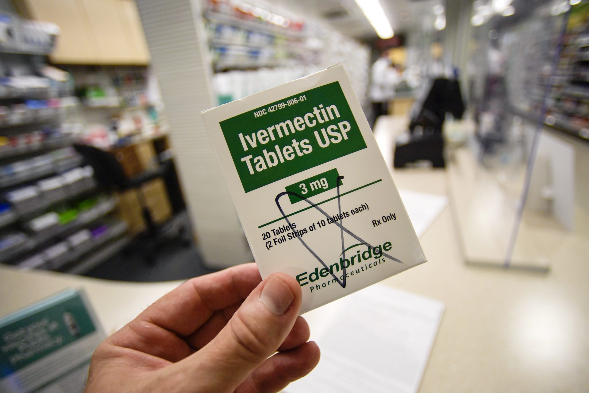 A box of ivermectin is shown in a pharmacy as pharmacists work in the background, Thursday, Sept. 9, 2021, in Ga.