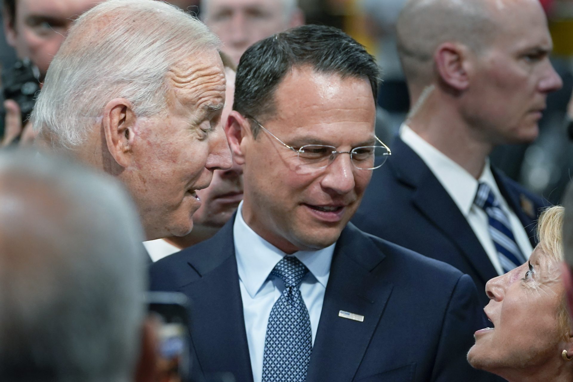 In this July 28, 2021 file photo Pennsylvania Attorney General Josh Shapiro, center, and President Joe Biden talk with people at the Lehigh Valley operations facility for Mack Trucks in Macungie, Pa.