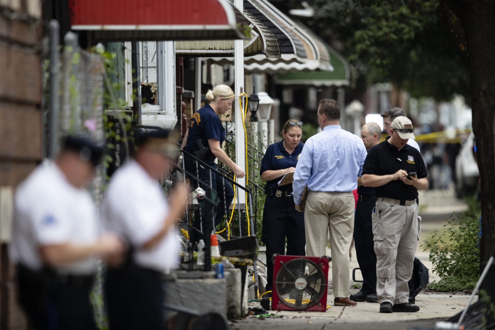In this Thursday, Aug. 15, 2019, file photo, officers conduct an investigation at the scene of a standoff with police in Philadelphia. 