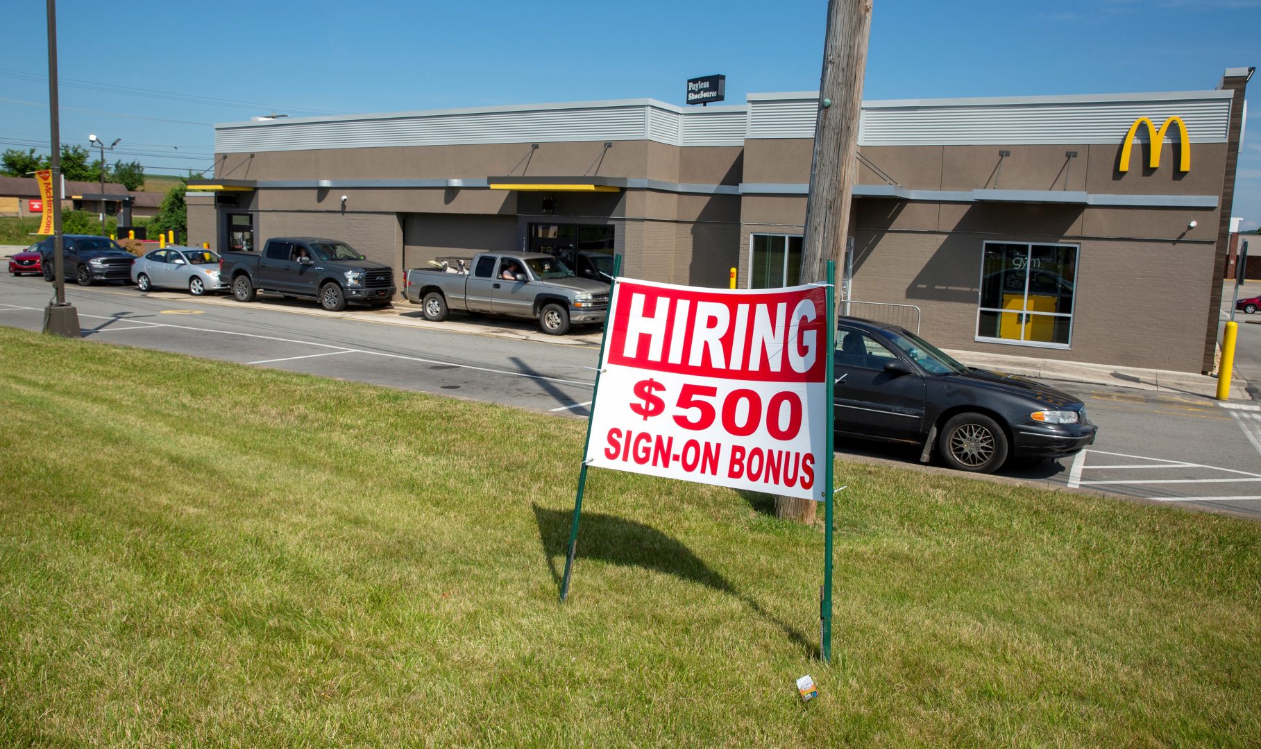 A hiring sign offering a $500 bonus is posted in front of a McDonald's fast-food restaurant in Mount Pleasant, Pennsylvania, on Sunday, June 27, 2021. 