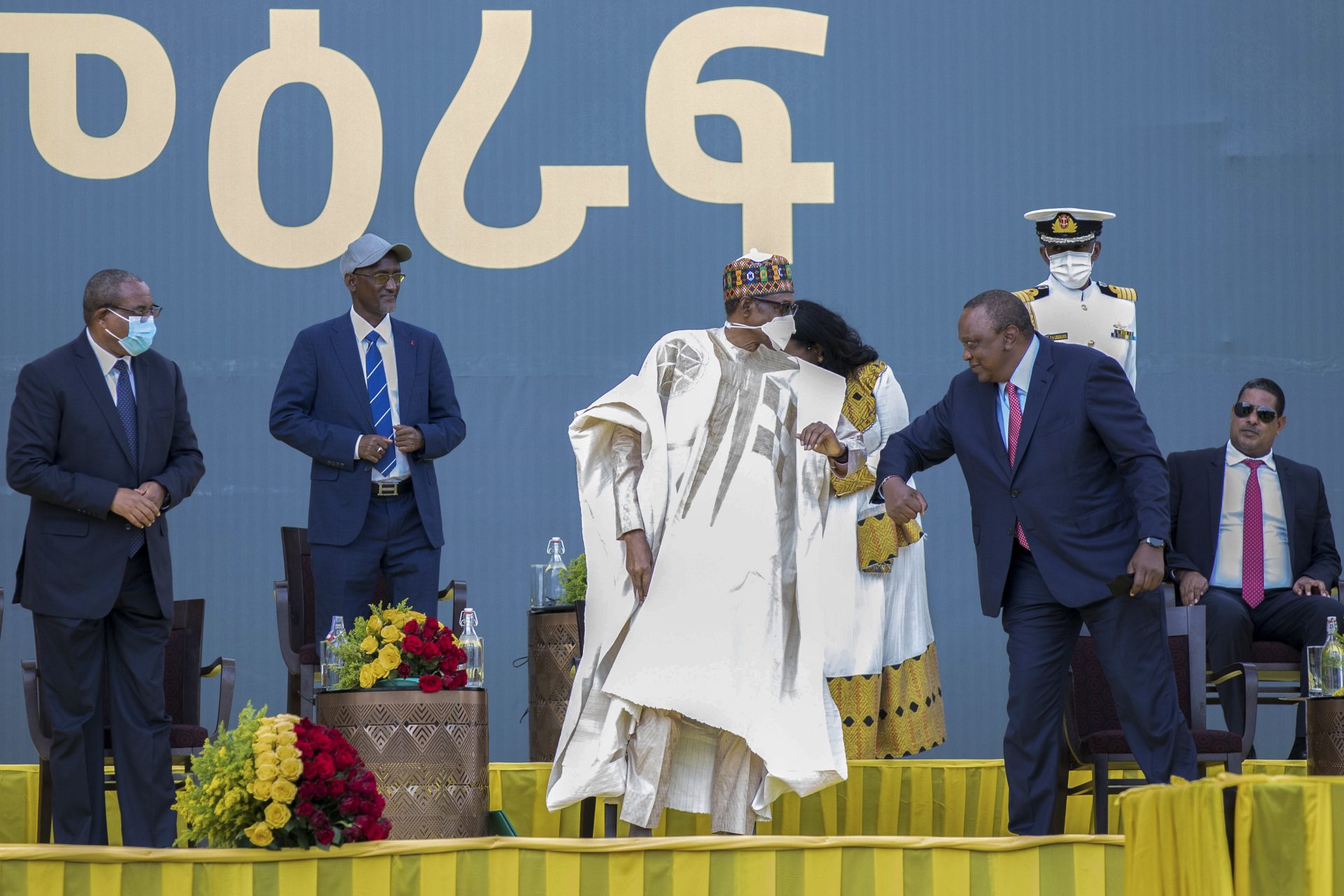 Kenya's President Uhuru Kenyatta, right, greets Nigeria's President Muhammadu Buhari, center, at the inauguration ceremony of Ethiopia's President Abiy Ahmed after he was sworn in for a second five-year term, in the capital Addis Ababa, Ethiopia Monday, Oct. 4, 2021.