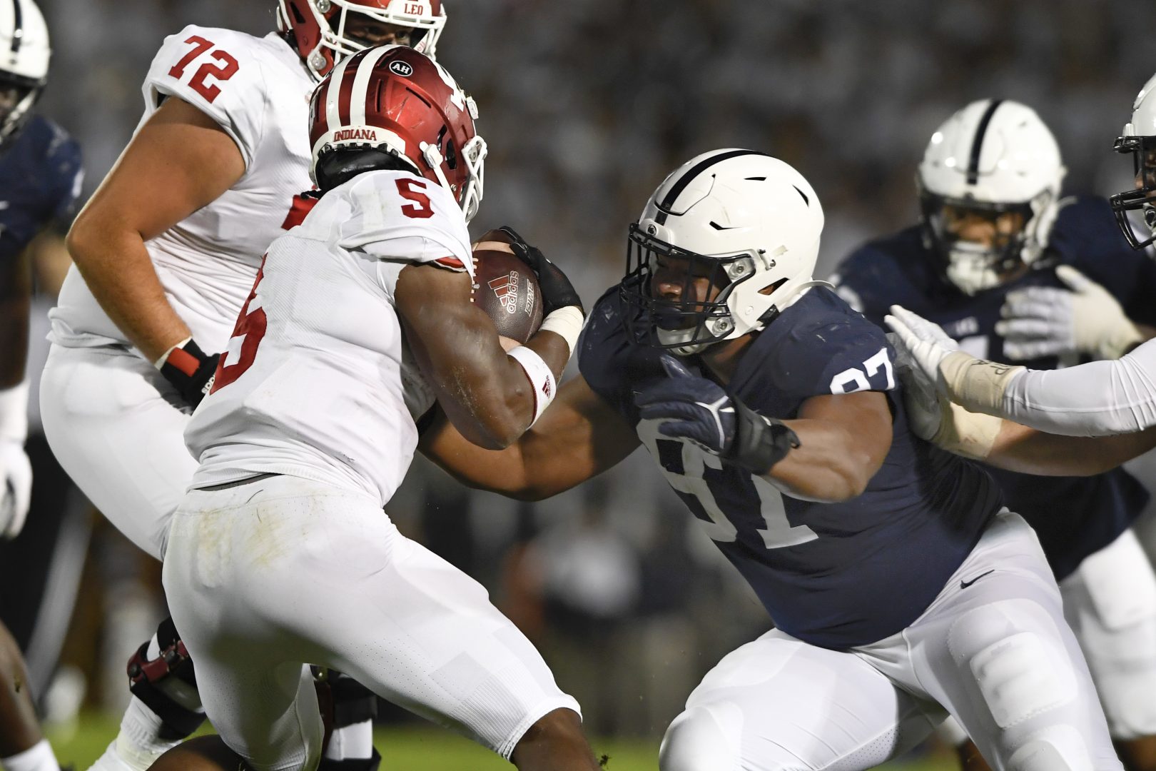 Penn State defensive tackle PJ Mustipher (97) tackles Indiana running back Stephen Carr (5) in the first half of their NCAA college football game in State College, Pa., on Saturday, Oct. 2, 2021. 