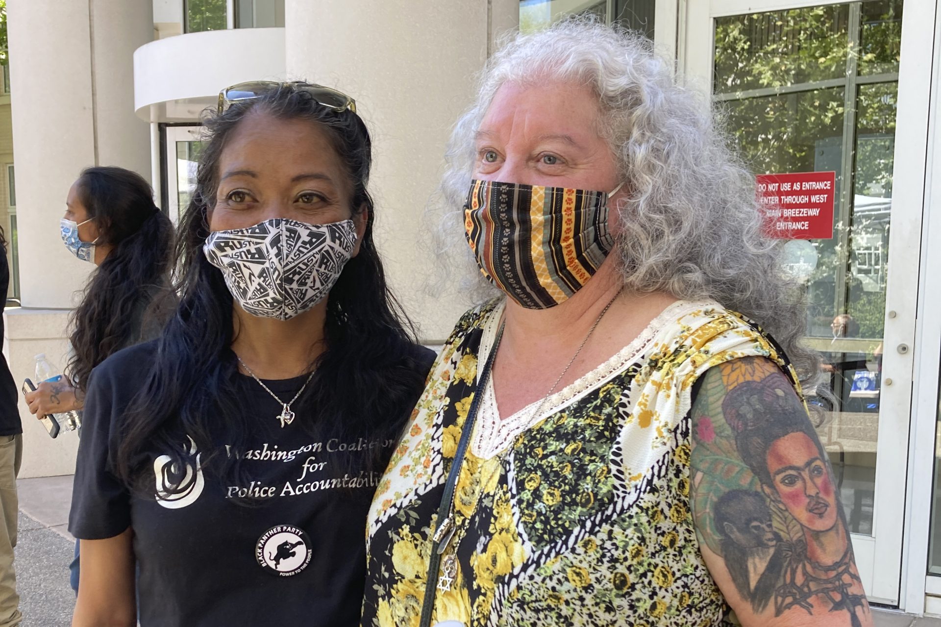 Kari Sarey, left, the mother of Jesse Sarey — who was killed by Auburn police Officer Jeff Nelson in 2019 — stands with Elaine Simons, who briefly fostered Jesse Sarey when he was young, Thursday, June 3, 2021, outside the Maleng Regional Justice Center in Kent, Wash. 