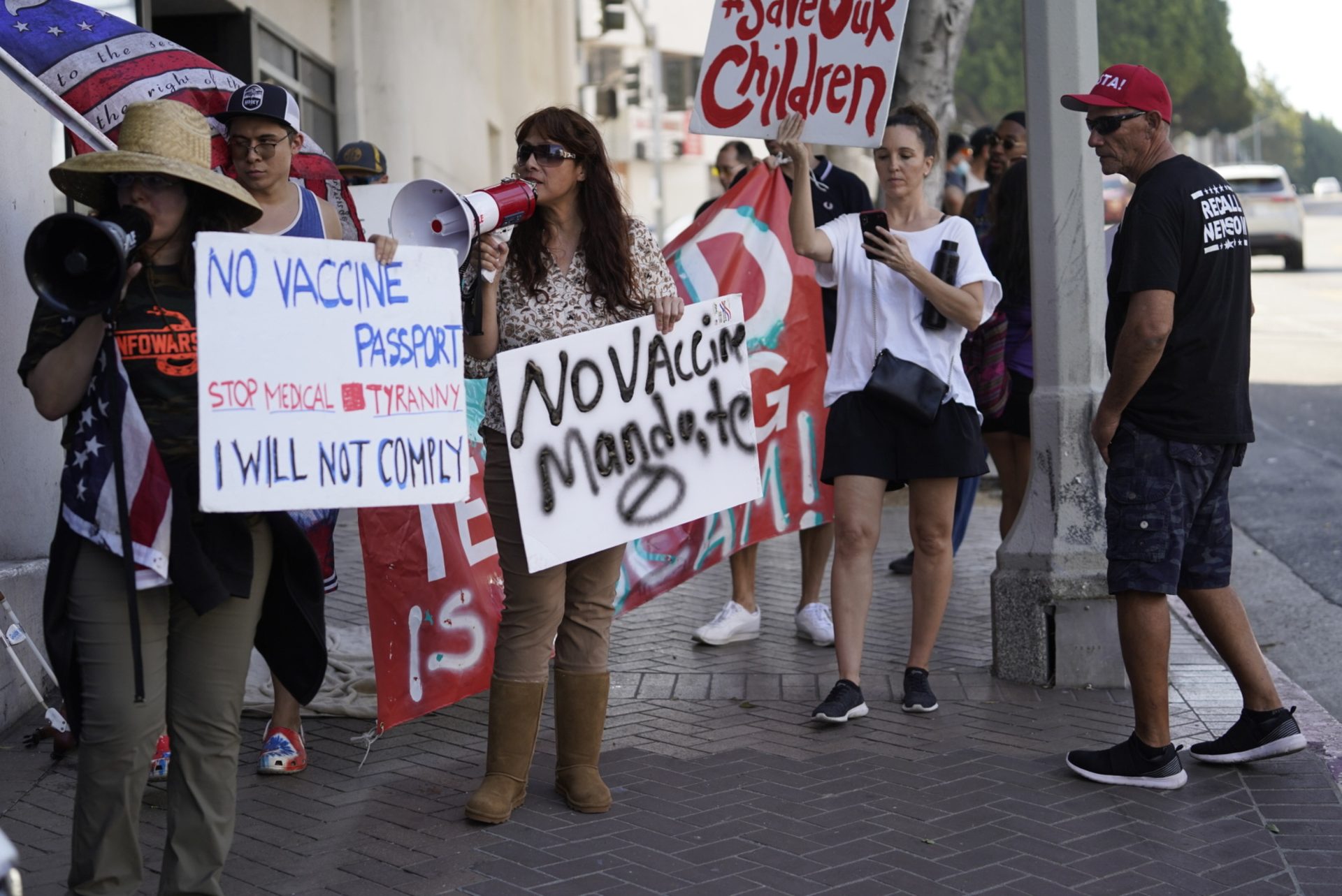 Anti-vaccine mandate protesters rally outside the garage doors of the Los Angeles Unified School District, LAUSD headquarters in Los Angeles Thursday Sept. 9, 2021.