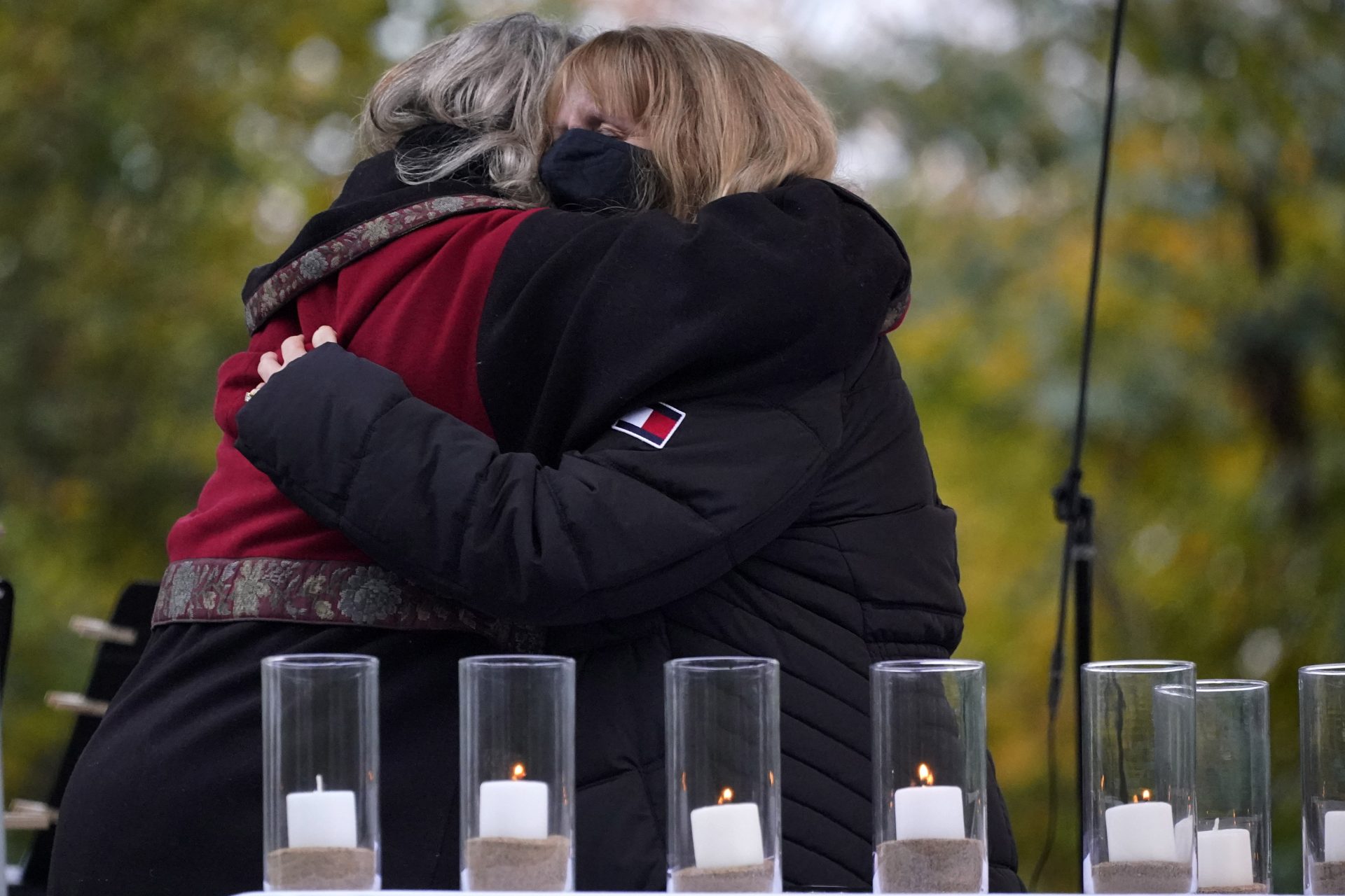 Family members embrace during a Commemoration Ceremony Wednesday, Oct. 27, 2021, in Pittsburgh, after lighting a candle in memory of Melvin Wax, one of 11 worshippers killed three years ago, when a gunman opened fire at the Tree of Life Synagogue in the Squirrel Hill neighborhood of Pittsburgh.