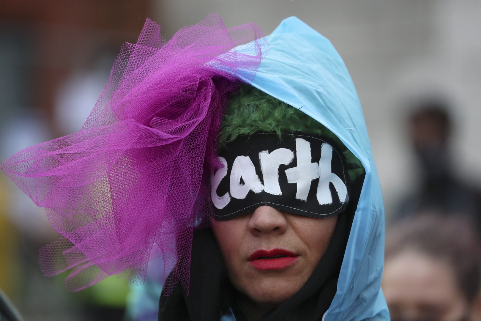A climate activist takes part in a demonstration outside the venue of the COP26 U.N. Climate Summit in Glasgow, Scotland, Friday, Nov. 12, 2021. Negotiators from almost 200 nations were making a fresh push Friday to reach agreements on a series of key issues that would allow them to call this year's U.N. climate talks a success. (AP Photo/Scott Heppell)