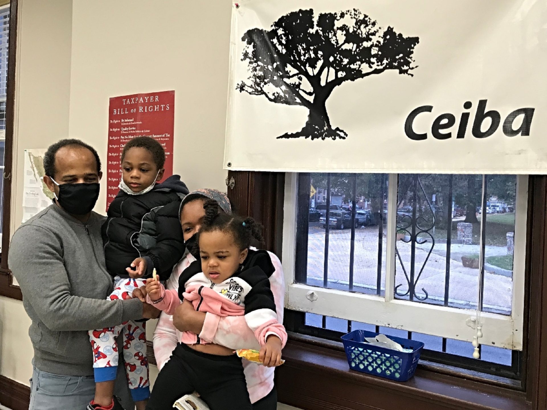 Jose and Rosa hold their children, Helen and Patrick, after getting tax help at Ceiba’s office in Philadelphia.