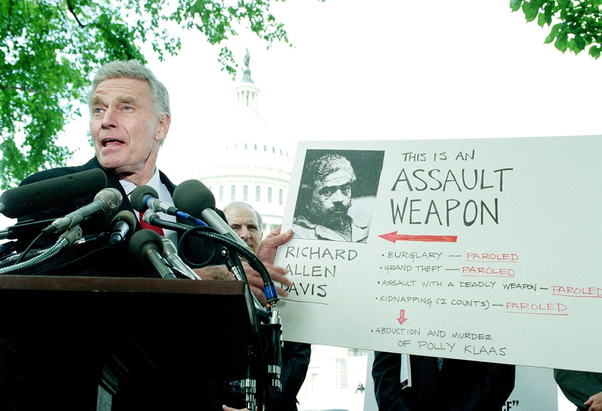 American actor and President of the NRA, Charlton Heston, holds up a placard as he meets the press outside Capitol Hill, Washington D.C., on May 3, 1994,