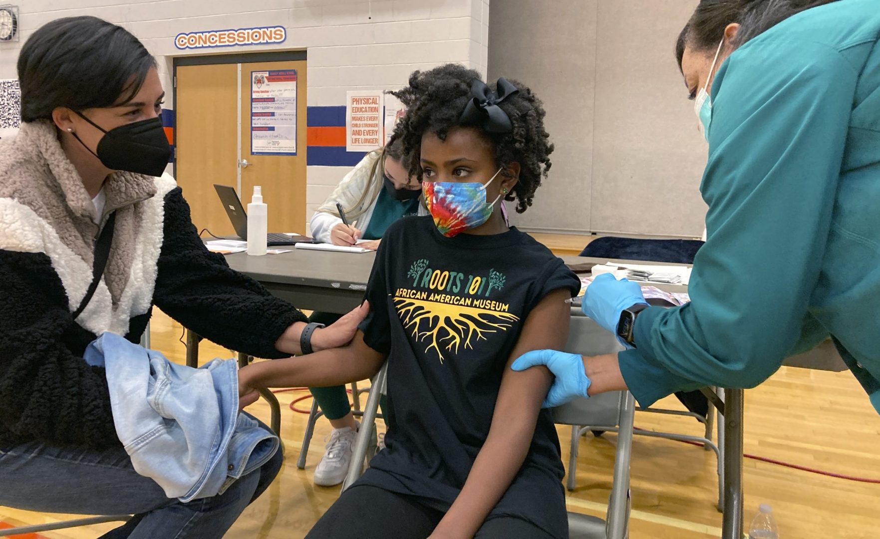 Cadell Walker comforts her daughter Solome, 9, as nurse Cindy Haskins administers a Pfizer COVID-19 shot at a vaccination clinic for young students at Ramsey Middle School on Saturday, Nov. 13, 2021 in Louisville, Ky.  