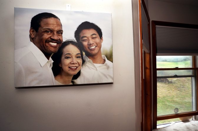 A family photo hangs on a wall in the dining room of Fe and Gareth Hall's home in Stroudsburg.