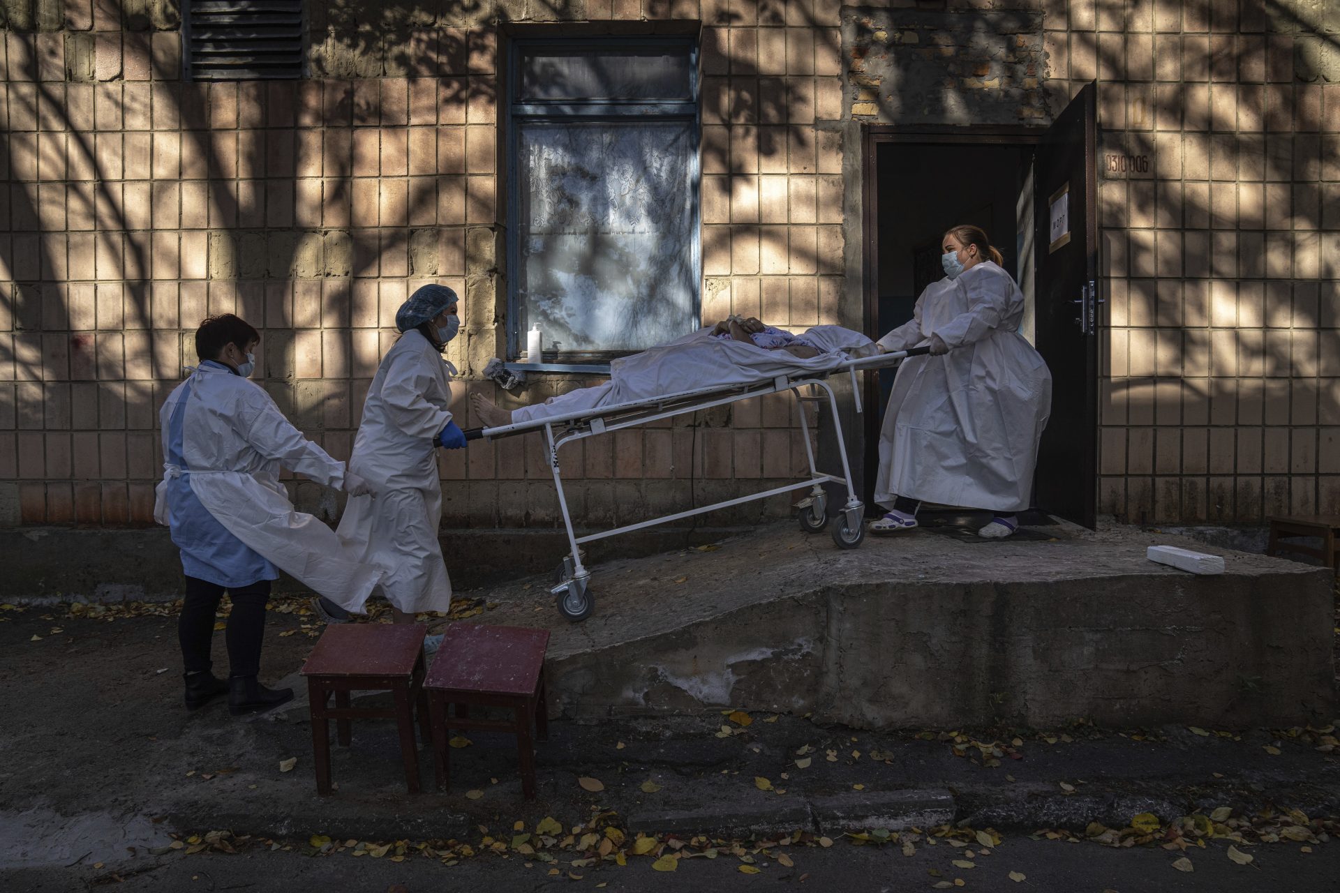 Medical staff members transport a body of a patient who died of the coronavirus at the morgue of the city hospital 1 in Rivne, Ukraine, Oct. 22, 2021.