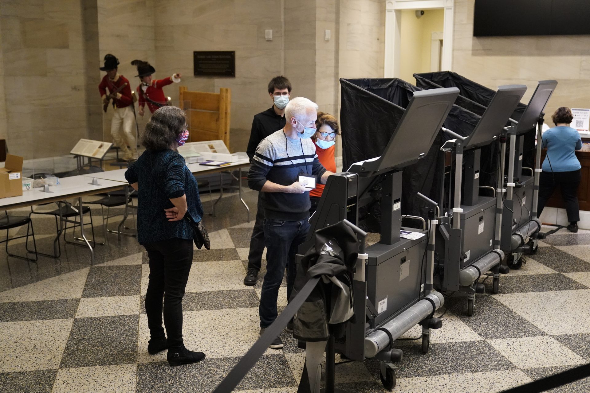 Election workers prepare for voters at the polling place located in the Museum of the American Revolution in Philadelphia, Tuesday, Nov. 2, 2021.