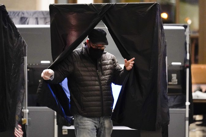 A voter wearing a protective face mask as a precaution against the coronavirus, steps from the voting booth after casting a ballot at a polling place at the Museum of the American Revolution in Philadelphia, Tuesday, Nov. 2, 2021.