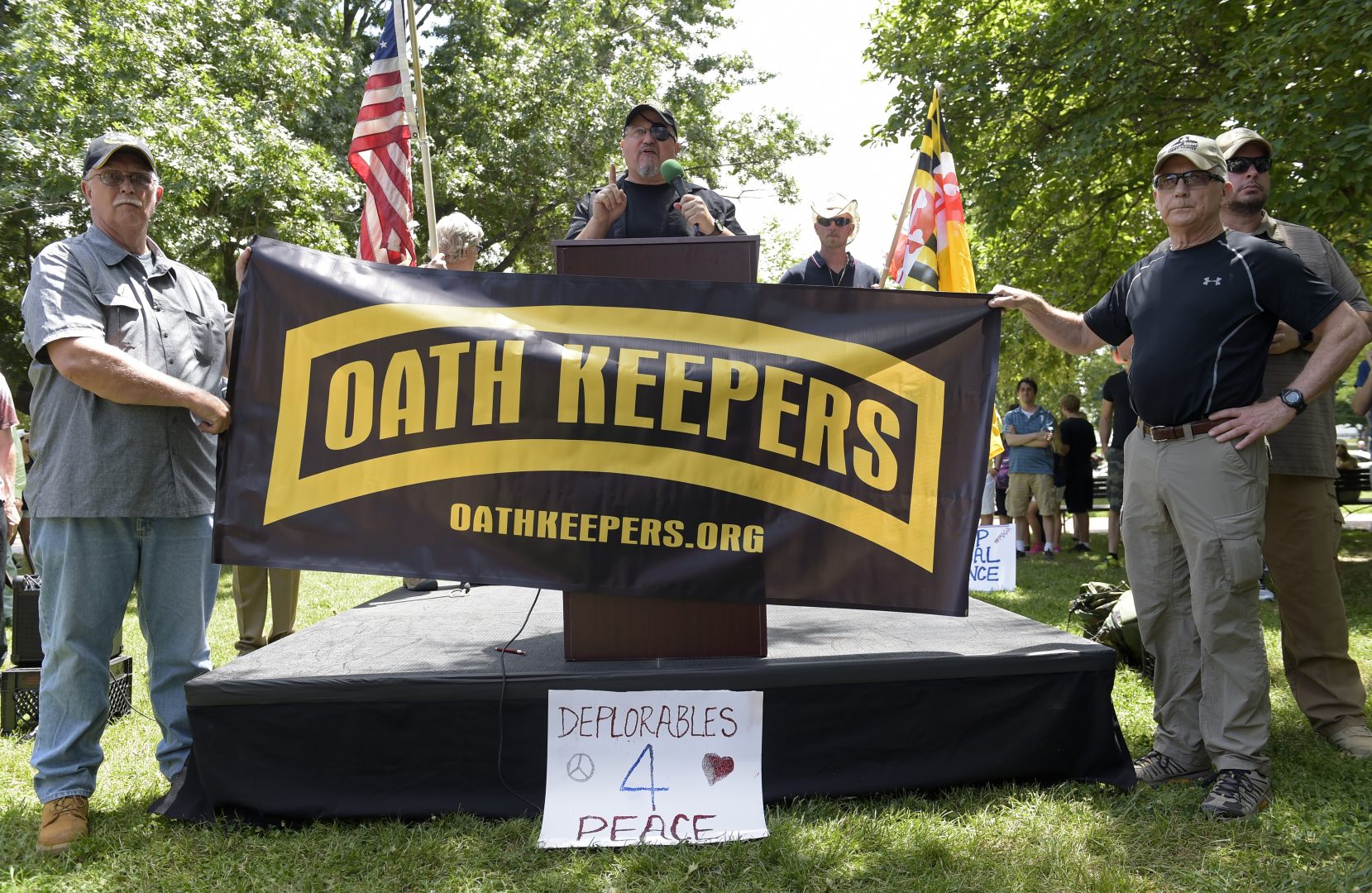 Stewart Rhodes, founder of the citizen militia group known as the Oath Keepers, center, speaks during a rally outside the White House in Washington, Sunday, June 25, 2017.