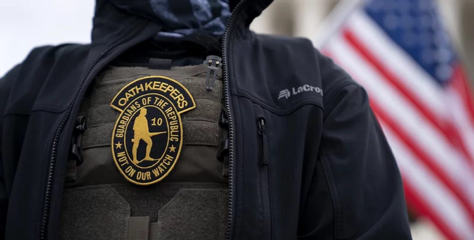 A demonstrator wears a badge for the extremist group the Oath Keepers on a protective vest during a protest outside the Supreme Court in Washington, D.C., on Jan. 5, 2021.