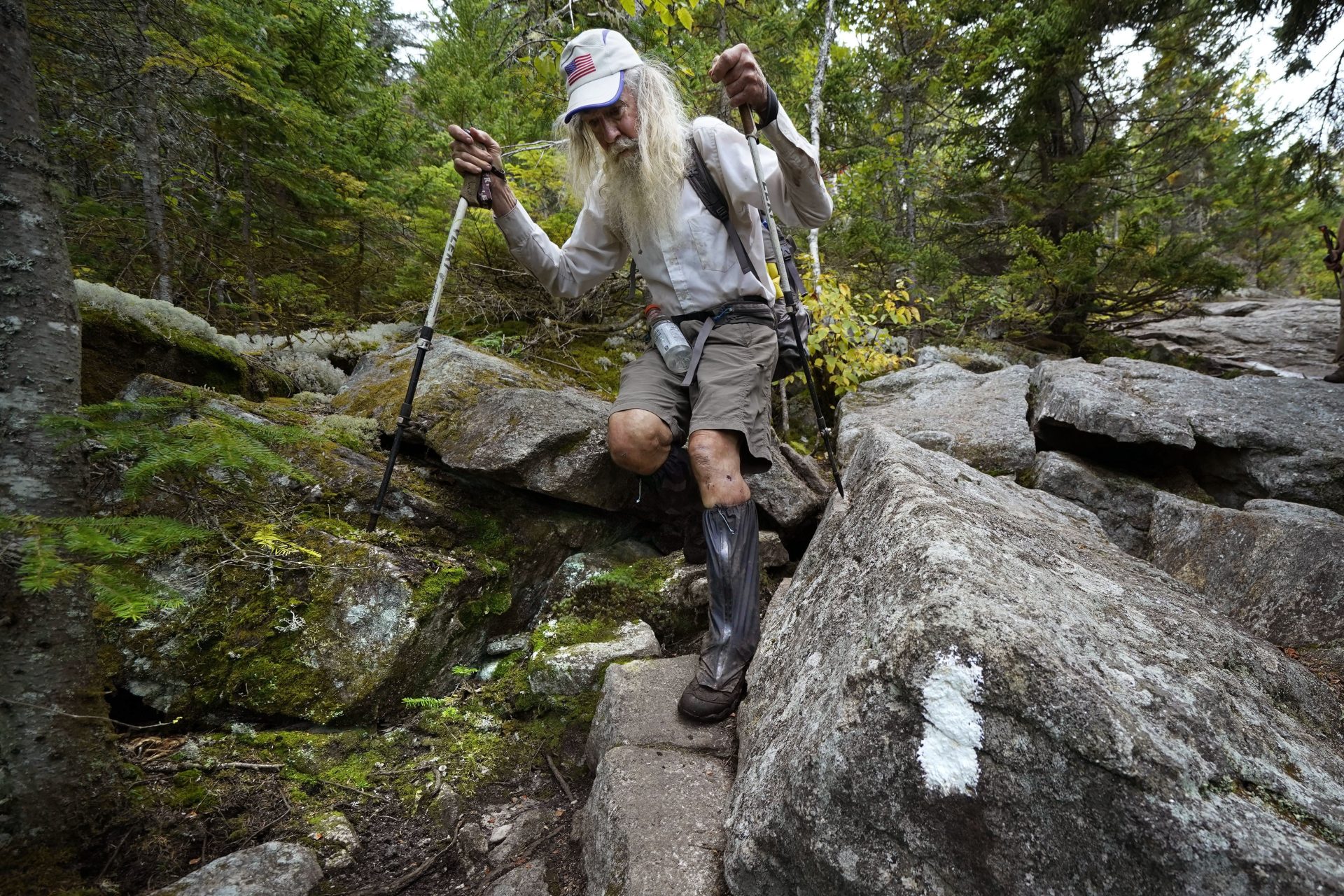 M.J. Eberhart, 83, carefully makes his way through large rocks while descending Mount Hayes on the Appalachian Trail, Sunday, Sept. 12, 2021, in Gorham, New Hampshire.