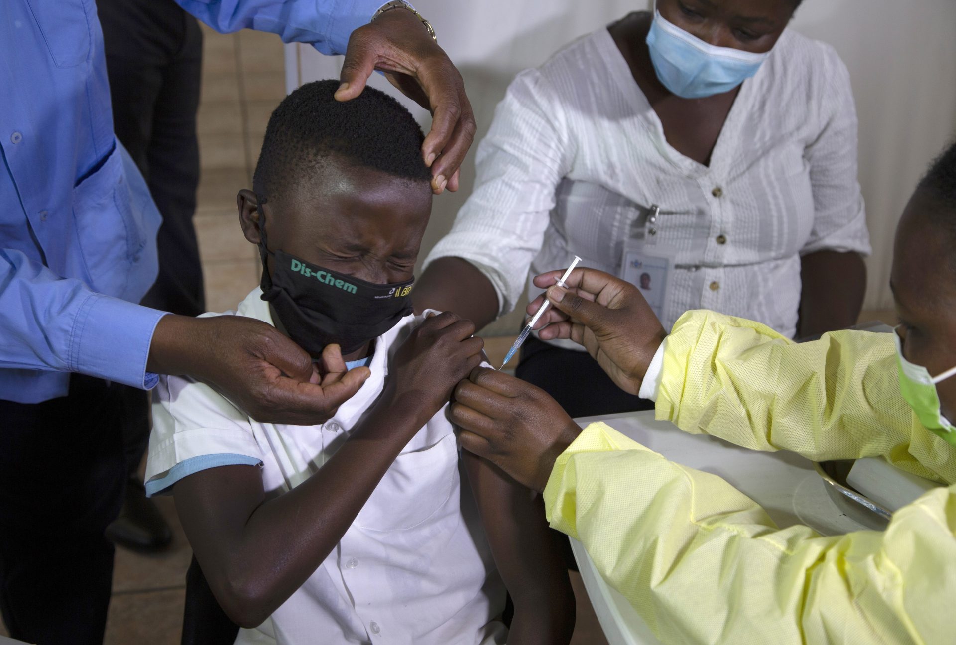 A child winces as he receives his Pfizer vaccine against COVID-19 in Diepsloot Township near Johannesburg, Thursday, Oct. 21, 2021.