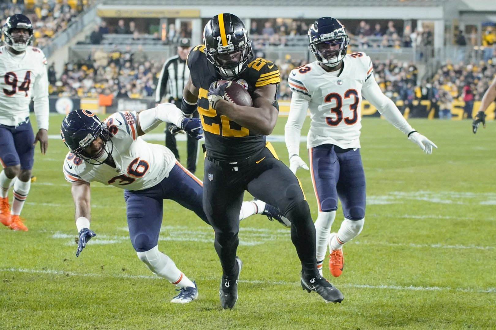 Pittsburgh Steelers running back Najee Harris (22) scores a touchdown past Chicago Bears defensive back DeAndre Houston-Carson (36) and cornerback Jaylon Johnson (33) in the first half of an NFL football game, Monday, Nov. 8, 2021, in Pittsburgh.