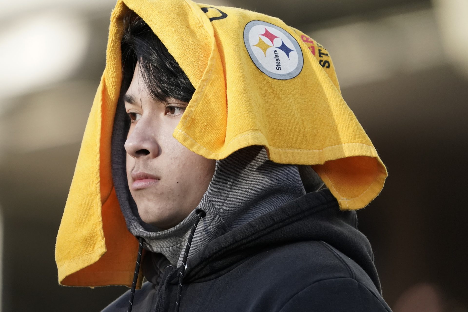 A Pittsburgh Steelers fan wears a Terrible Towel on his head as his team loses to the Cincinnati Bengals in an NFL football game, Sunday, Nov. 28, 2021, in Cincinnati.