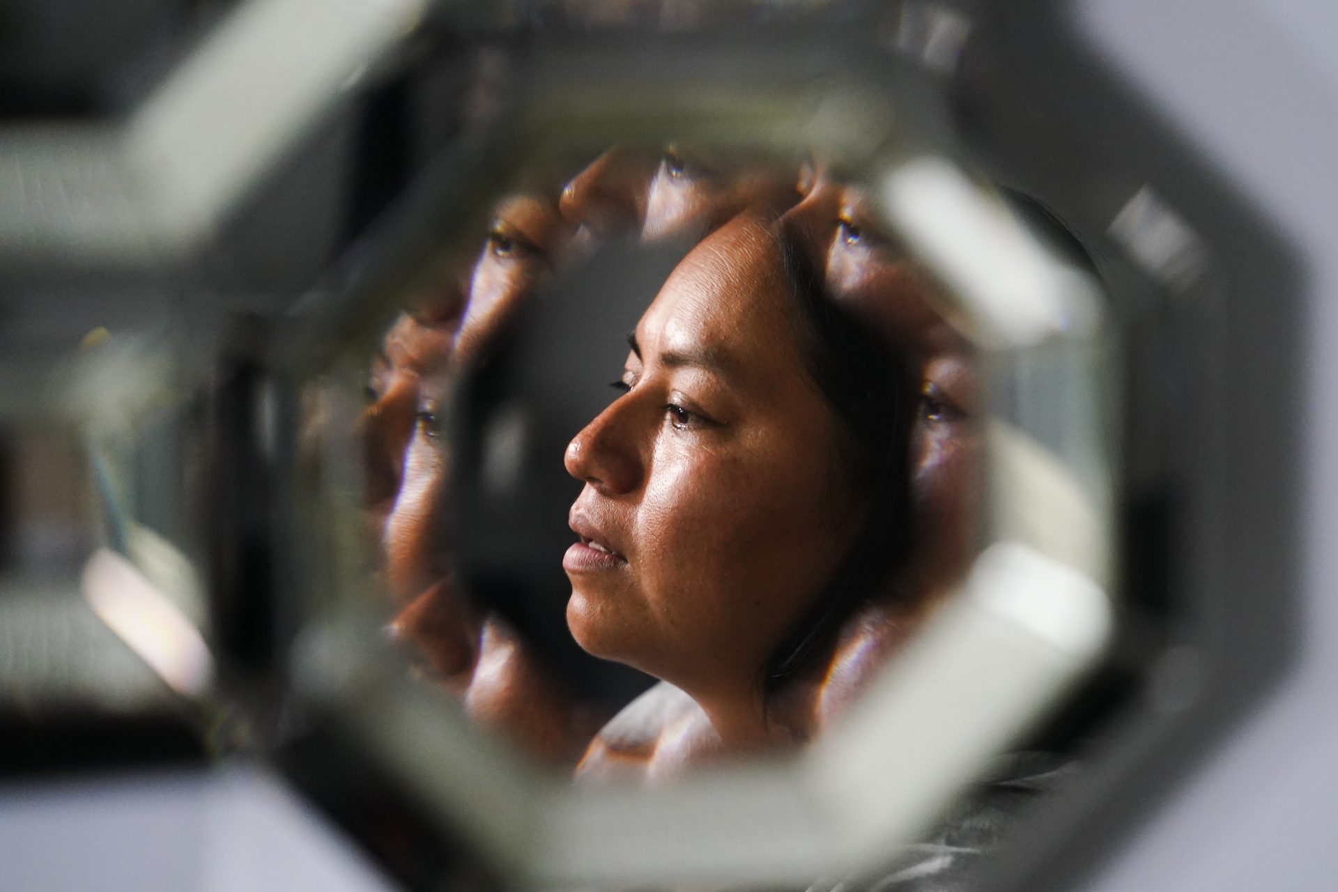 Lucia Altamirano, reflected in a mirror, speaks during an interview with The Associated Press in Philadelphia, Wednesday, Oct. 6, 2021. Philadelphia parents who don’t speak English say they’ve long been excluded from parts of their children’s education because of language barriers, an issue that's been exacerbated by the pandemic and the return to in-person learning.