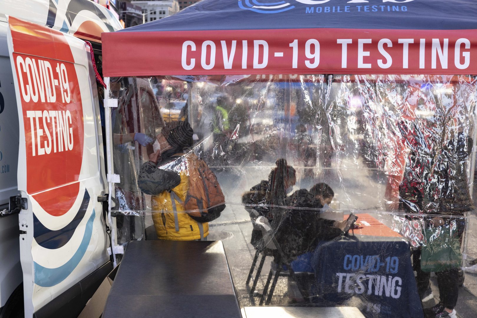 A person takes COVID-19 test in Times Square on Friday, Dec. 3, 2021, in New York. The omicron variant of COVID-19, which had been undetected in the U.S. before the middle of this week, was found in Pennsylvania on Friday, and had been discovered in at least five states by the end of Thursday, showing yet again how mutations of the virus can circumnavigate the globe with speed and ease.