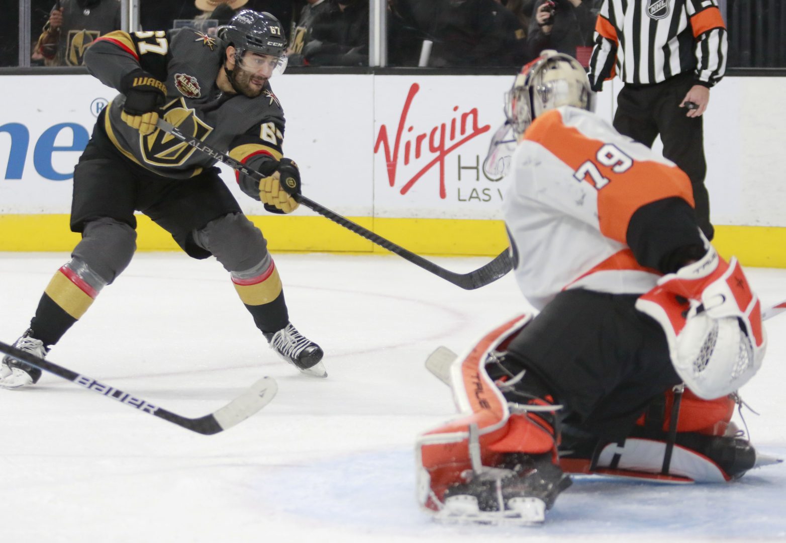 Vegas Golden Knights left wing Max Pacioretty (67) shoots and scores against Philadelphia Flyers goaltender Carter Hart (79) in the second period of an NHL hockey game Friday, Dec. 10, 2021, in Las Vegas. (AP Photo/Ronda Churchill)