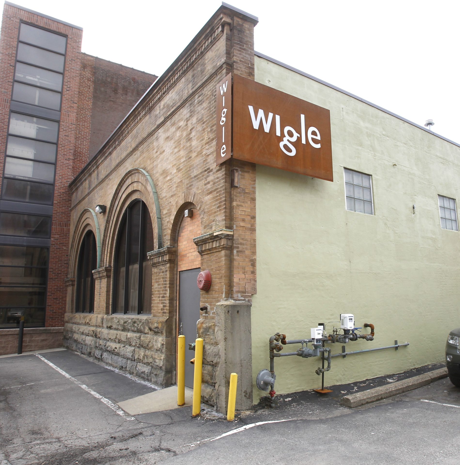 In this photo made on Friday, March 2, 2012, a steel sign is mounted on the corner of the Wigle Whiskey distillery in Pittsburgh's Strip District.