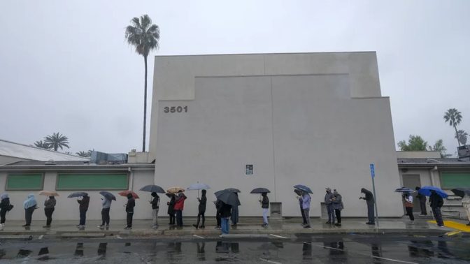 People wait in line for a free COVID-19 test outside Lincoln Park Recreation Center in Los Angeles on Thursday.