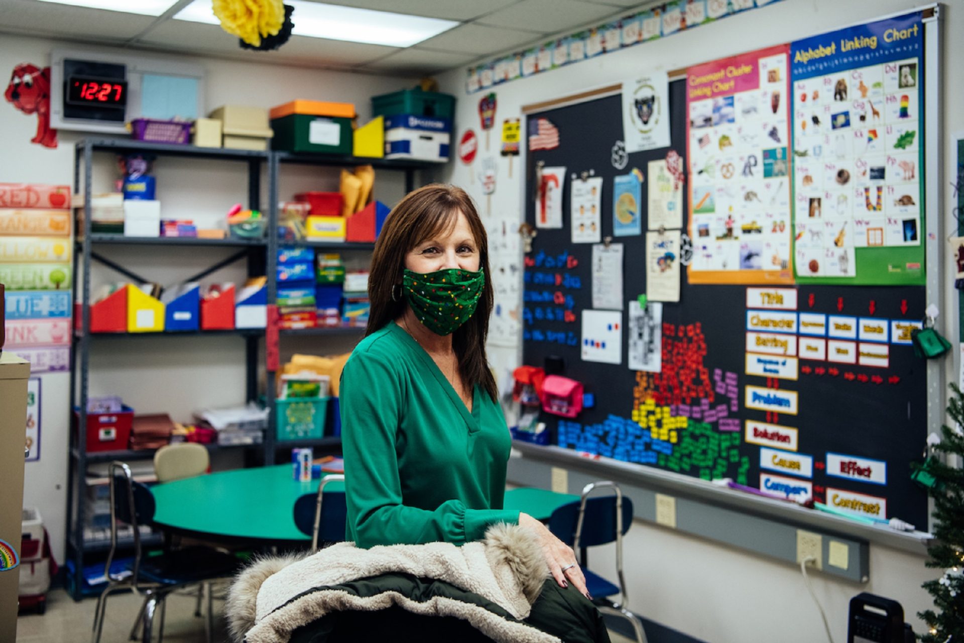 Maria Szczecina stands behind the desk chair in her classroom adorned with brightly colored educational tools. She is one of two Title 1 Reading teachers at the school. She used the word ”triage” to describe coping with inadequate funding and the state of the facility.
