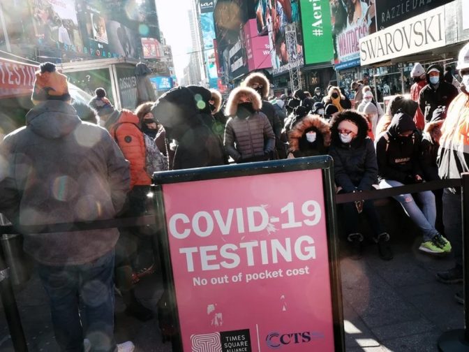 People wait in long lines in Times Square to get tested for COVID-19 on Monday. New York City, which was initially overwhelmed by the pandemic, has once again seen case numbers surge as the new omicron variant becomes dominant.