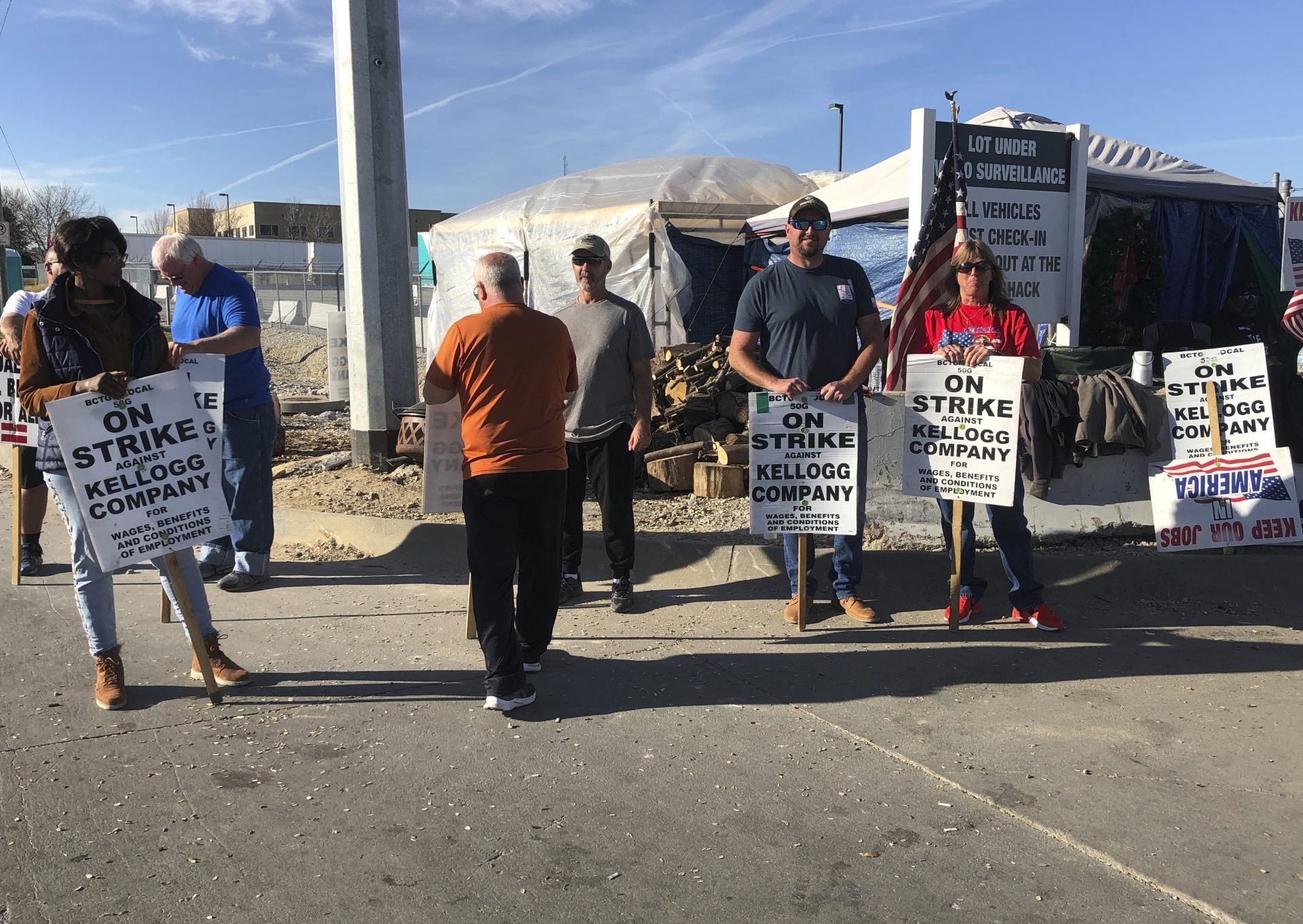 Striking Kellogg's workers stand outside the company's cereal plant in Omaha, Neb., Thursday, Dec. 2, 2021. The company and the union announced a tentative agreement Thursday that could end the strike that began Oct. 5.