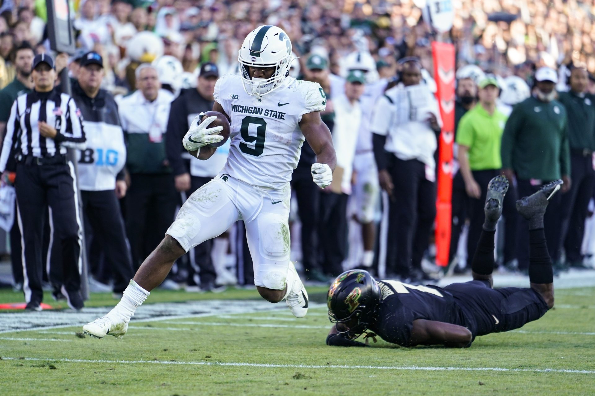 Michigan State running back Kenneth Walker III (9) breaks the tackle of Purdue cornerback Jamari Brown (7) on his way to a touchdown during the first half of an NCAA college football game in West Lafayette, Ind., Nov. 6, 2021.