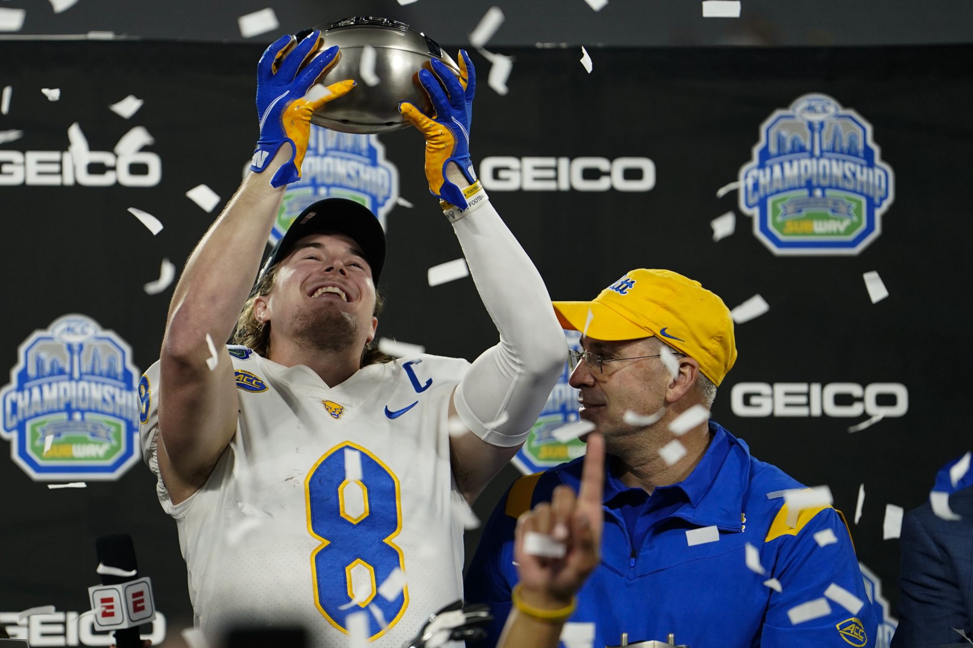 Pittsburgh quarterback Kenny Pickett and head coach Pat Narduzzi celebrate with the trophy after their win against Wake Forest in the Atlantic Coast Conference championship NCAA college football game Saturday, Dec. 4, 2021, in Charlotte, N.C.