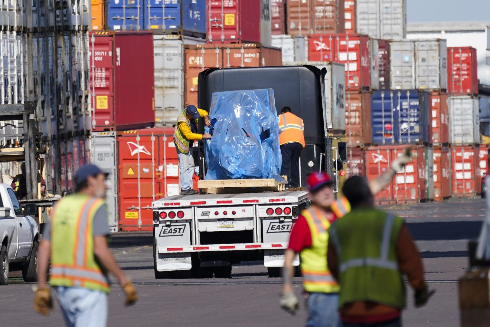 Workers handle cargo at the Port of Philadelphia, Thursday, Oct. 28, 2021. 