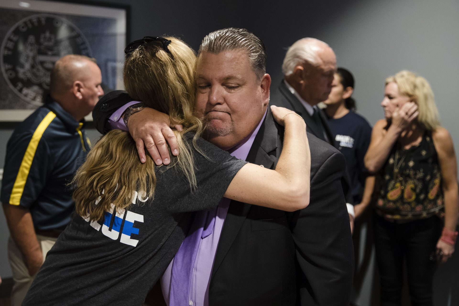 Police union President John McNesby embraces former Officer Ryan Pownall's wife Tina after a news conference in Philadelphia, Tuesday, Sept. 4, 2018.