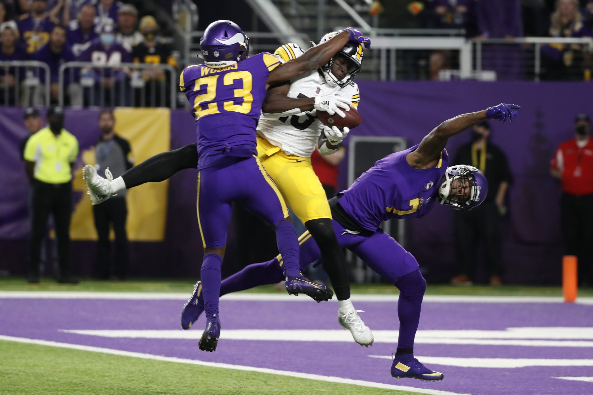 Pittsburgh Steelers wide receiver James Washington (13) catches a 30-yard touchdown pass between Minnesota Vikings free safety Xavier Woods (23) and cornerback Patrick Peterson (7) during the second half of an NFL football game, Thursday, Dec. 9, 2021, in Minneapolis.