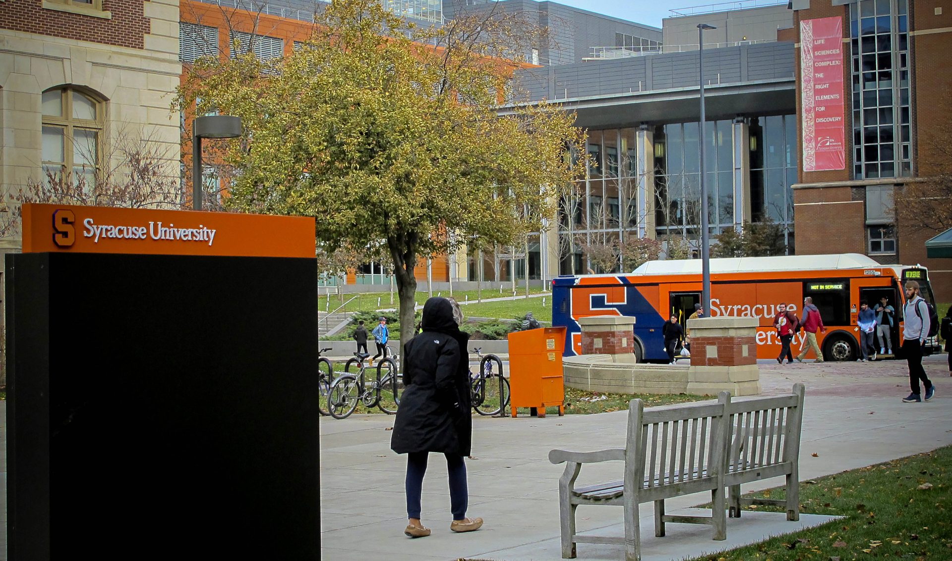 Students walk the campus on Syracuse University, Nov. 21, 2019, in New York.