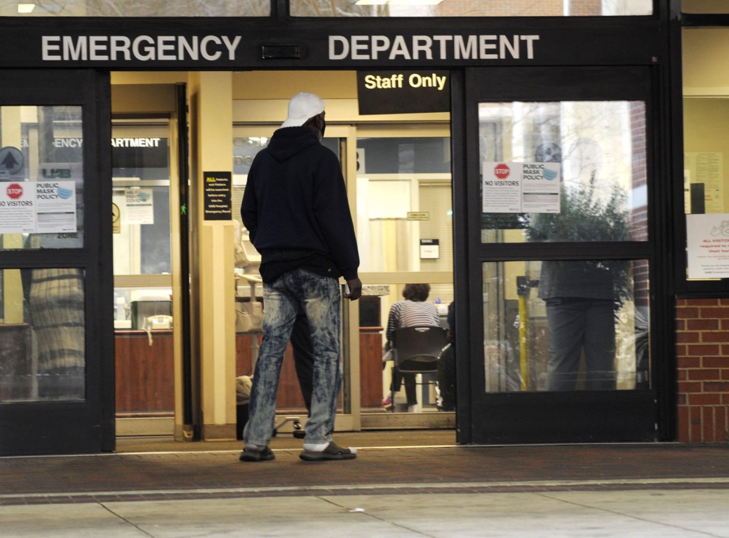 A man enters the emergency room at UAB Hospital in Birmingham, Ala., on Wednesday, Jan. 5, 2022.  A requirement to get vaccinated against COVID-19 kicks in Thursday, Jan. 26 for millions of health care workers in about half the states.  (AP Photo/Jay Reeves, File)