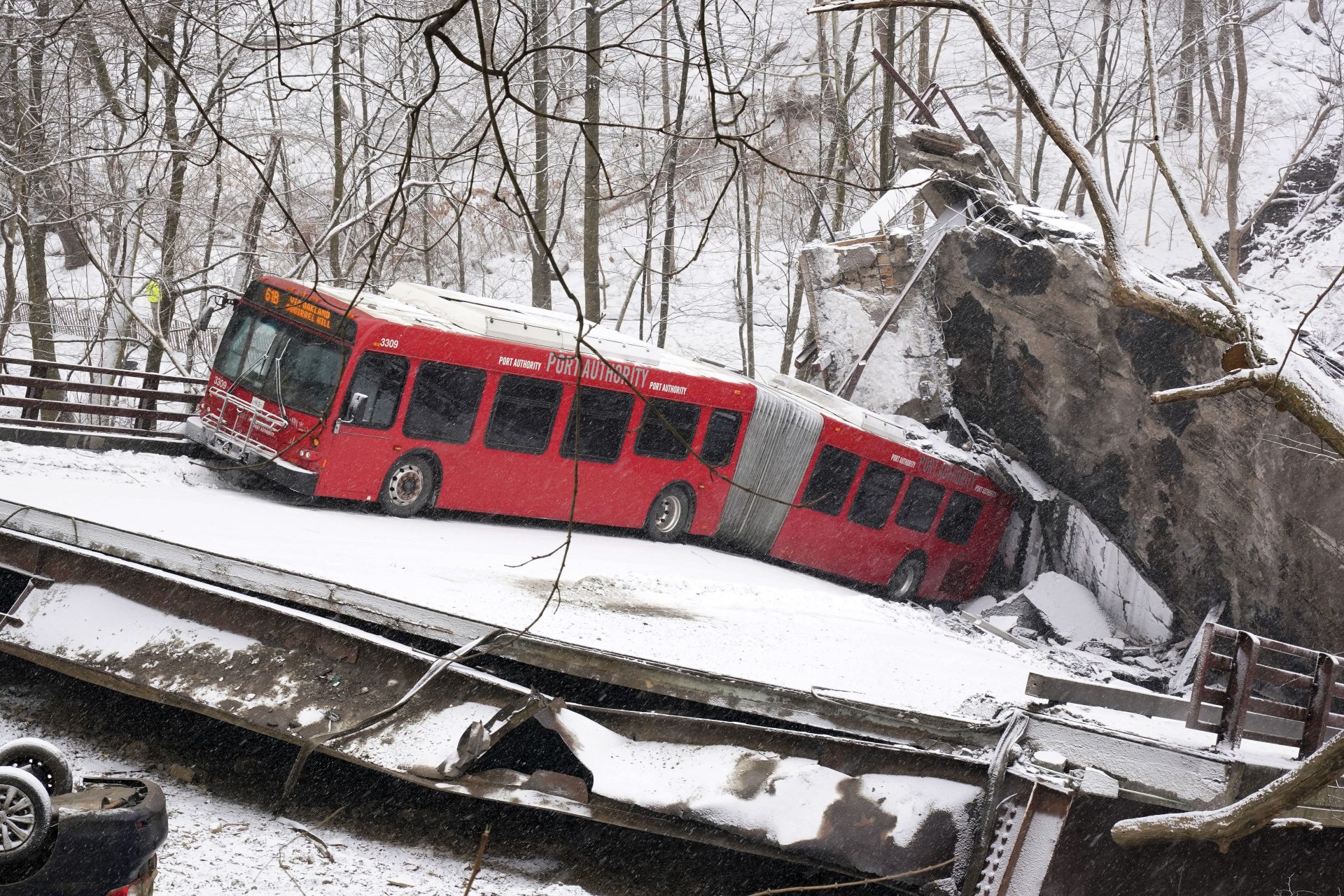 This is a Pittsburgh Transit Authority bus that was on the Fern Hollow Bridge in Pittsburgh when it collapsed Friday morning Friday, Jan. 28, 2022. (AP Photo/Gene J. Puskar)