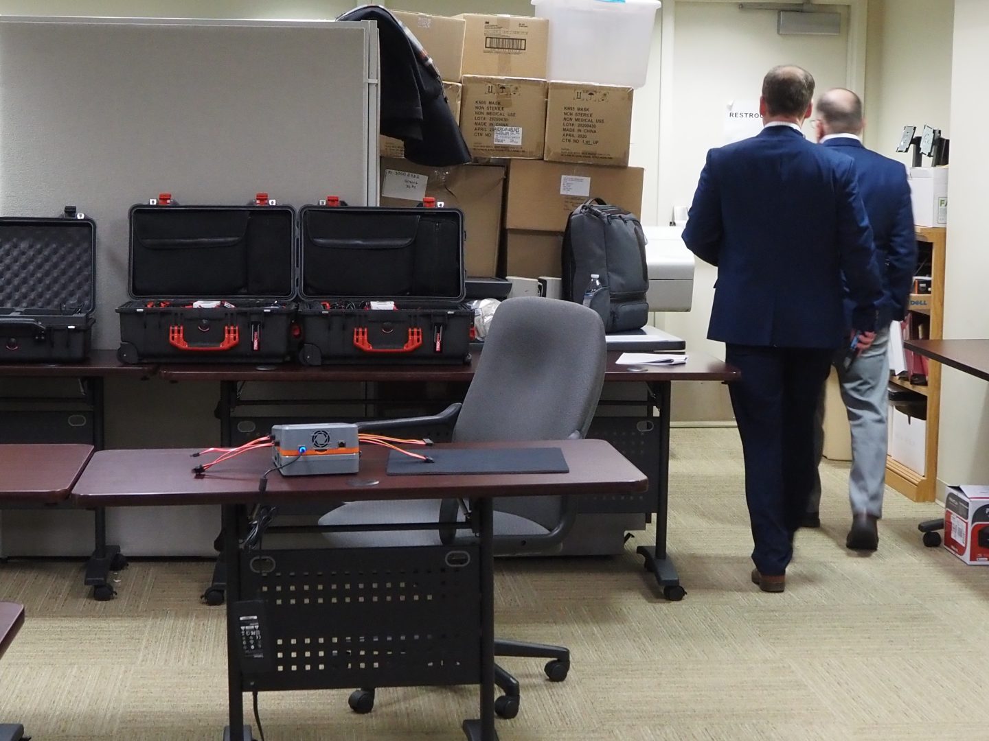 Officials walk past unidentified equipment purportedly to be used in an inspection of Fulton County's voting machines on Jan. 14, 2022. The inspection did not proceed as planned after the Pa. Supreme Court ordered a halt.