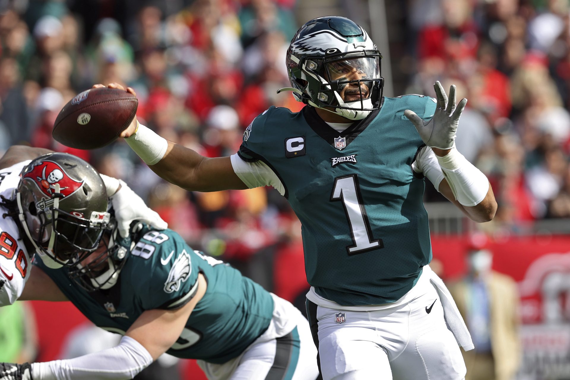 Philadelphia Eagles quarterback Jalen Hurts (1) throws a pass against the Tampa Bay Buccaneers during the first half of an NFL wild-card football game Sunday, Jan. 16, 2022, in Tampa, Fla.