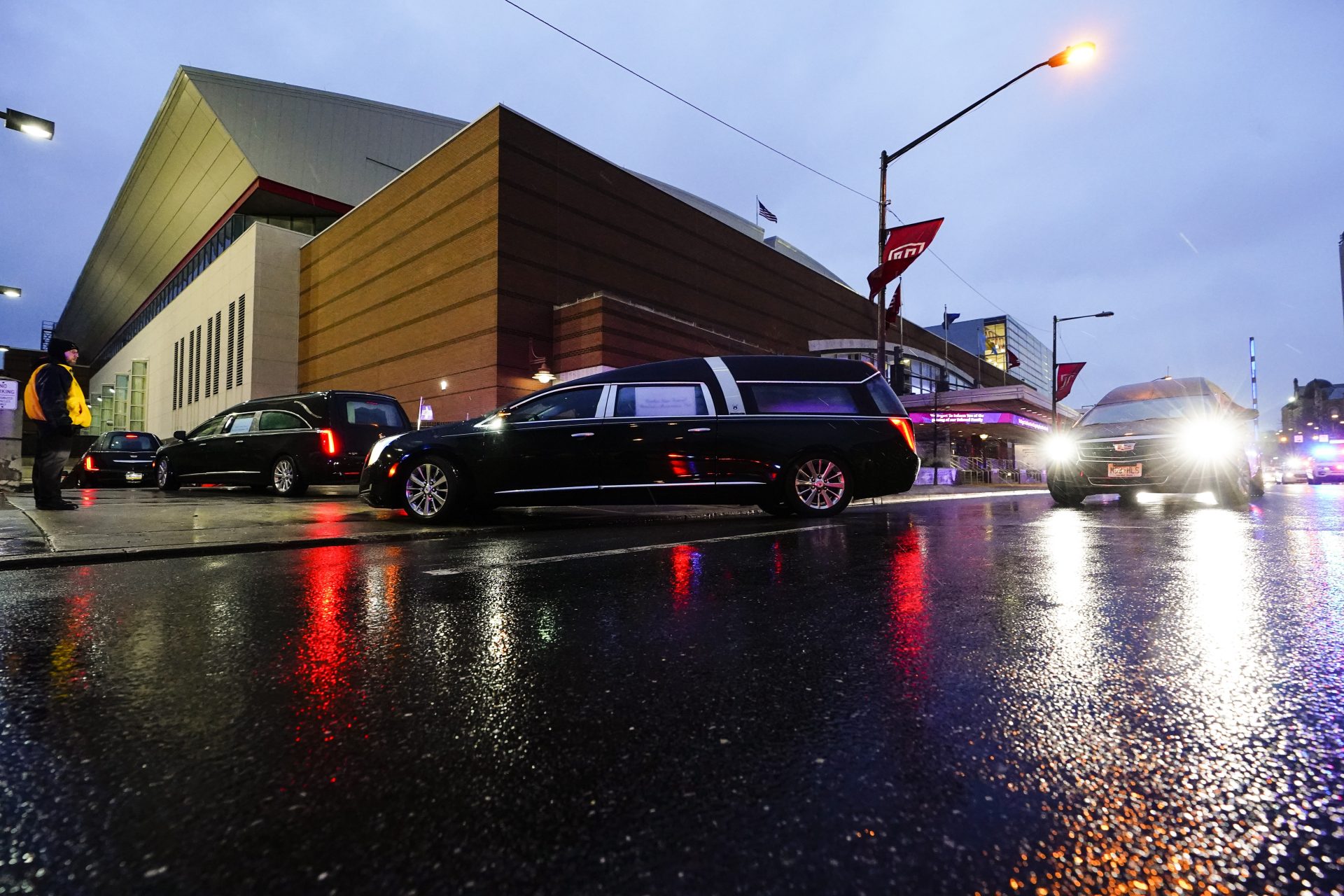 The funeral procession for the victims of a deadly row house fire arrive for services at Temple University in Philadelphia, Monday, Jan. 17, 2022. Officials say it's the city's deadliest single fire in at least a century.