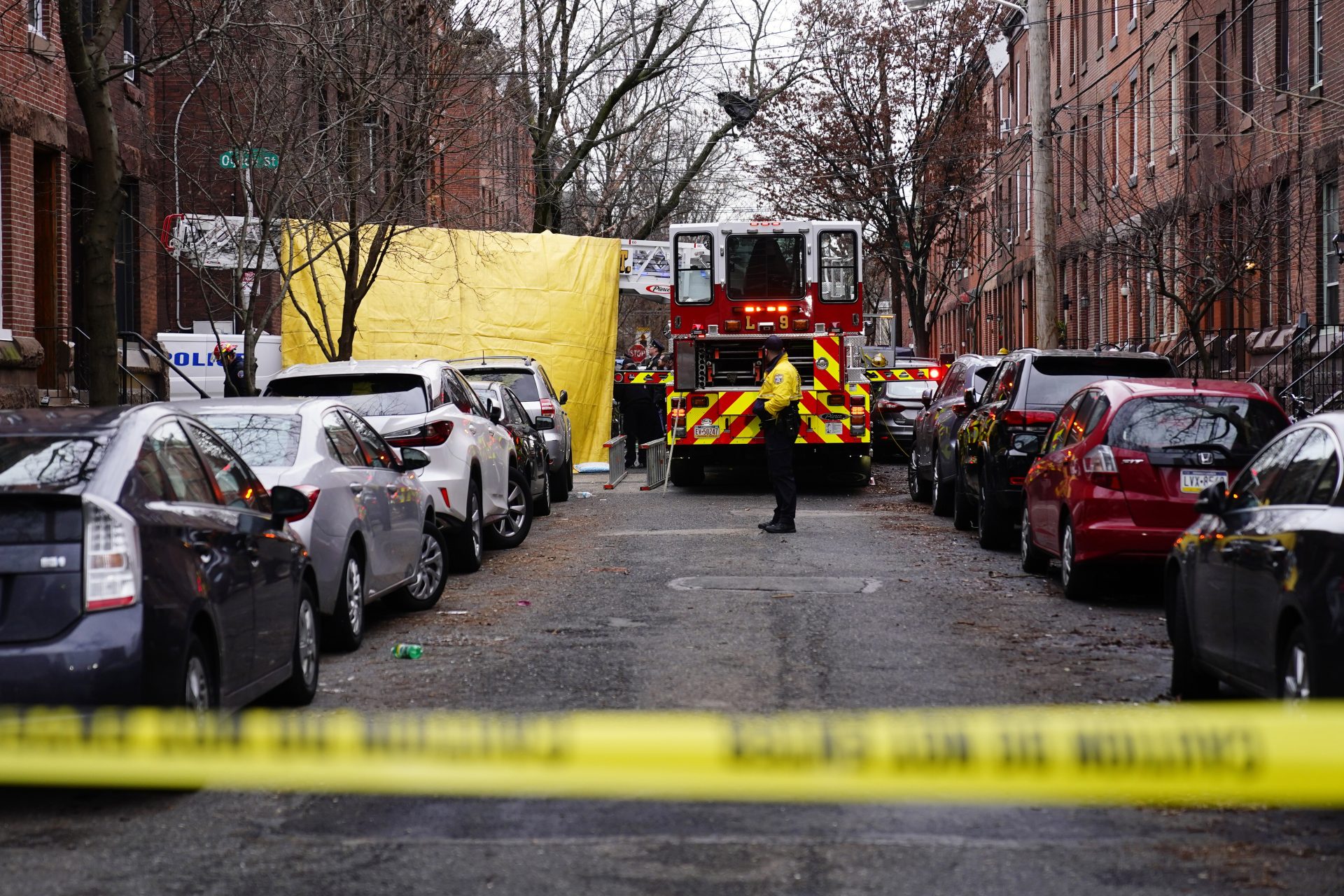 Philadelphia firefighters and police work at the scene of a deadly row house fire, Wednesday, Jan. 5, 2022, in the Fairmount neighborhood of Philadelphia.